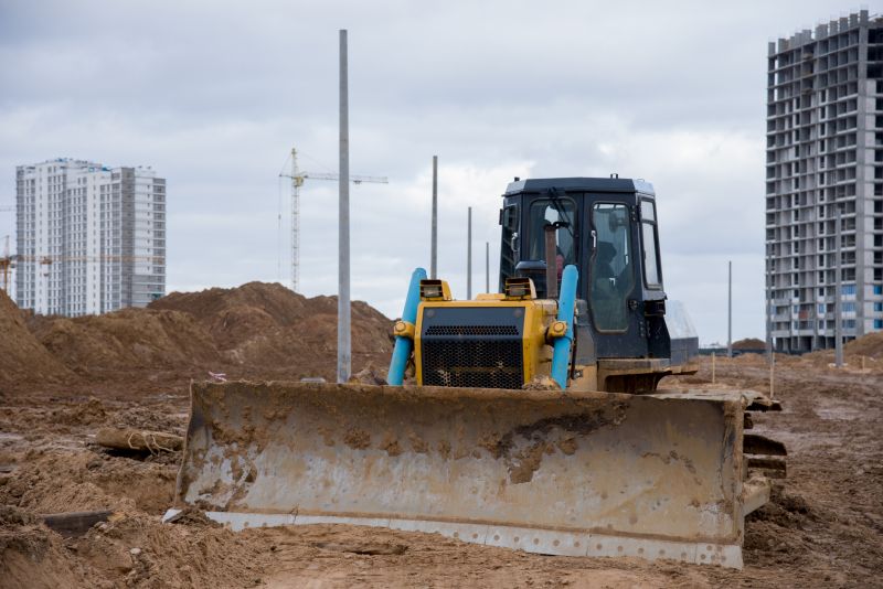 Prepares land for construction and development projects